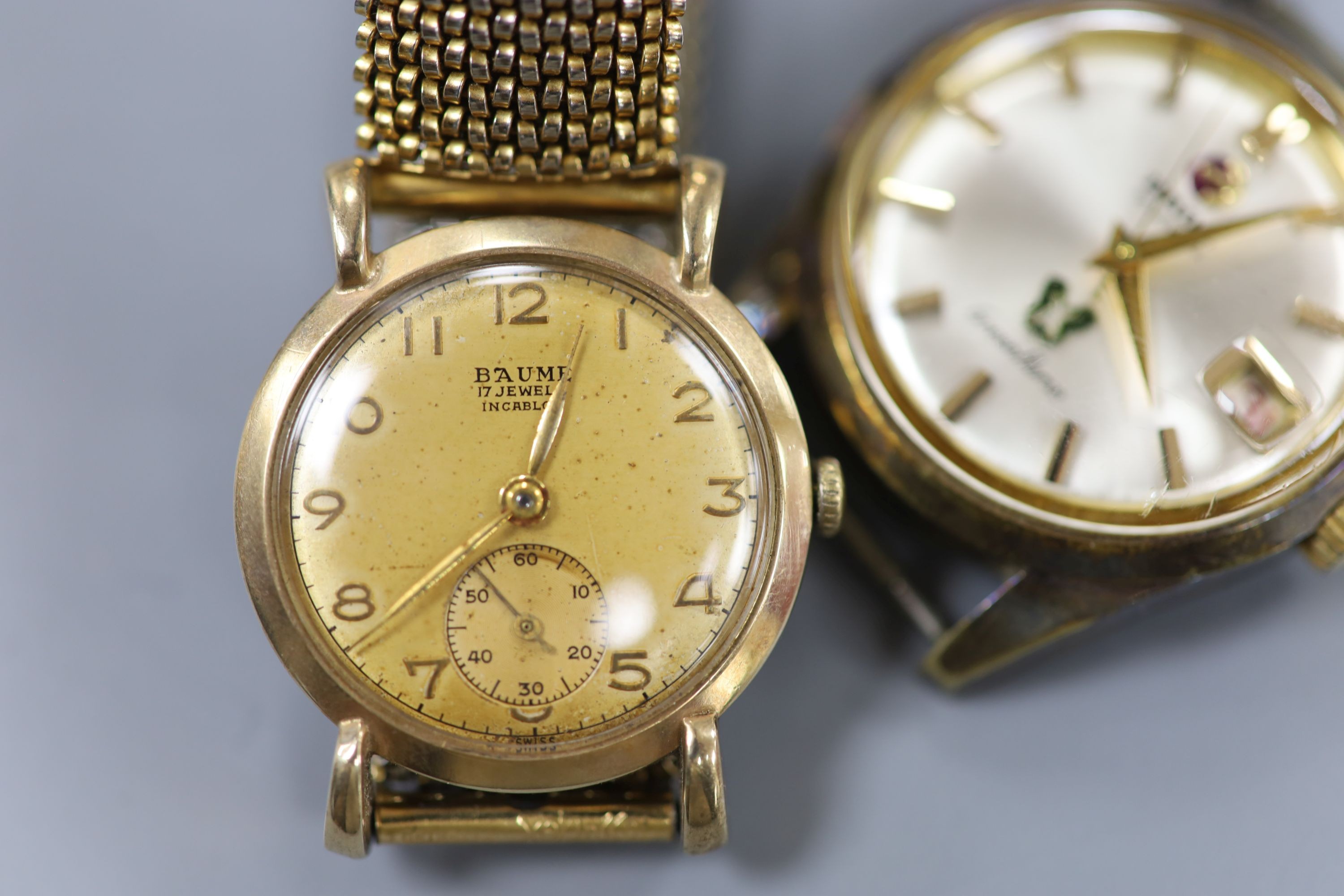 A gentleman's 9ct gold Baume manual wind wrist watch, on a gilt metal flexible strap and a gentleman's steel Rado Gren Horse wrist watch, no strap.